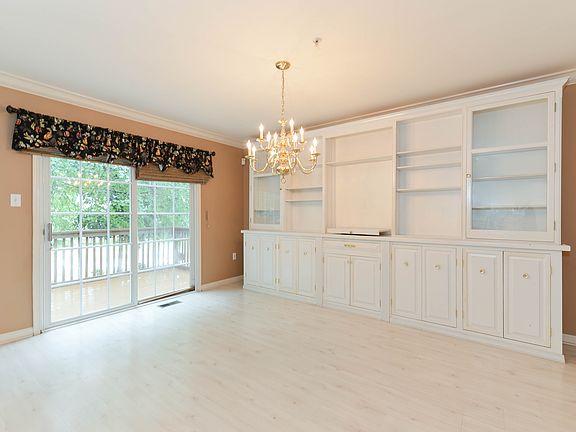 Dining area with massive built-ins, slider to deck