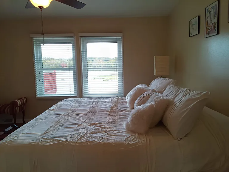 King ultra plush bed with lots of pillows for a relaxing river view