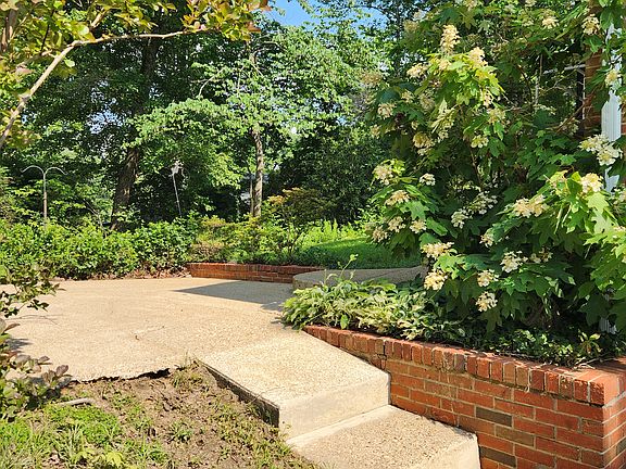 Steps to patio from driveway, and to side door entry leading to kitchen.