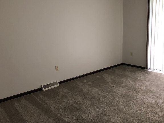 New carpet and pale gray walls in the living room.