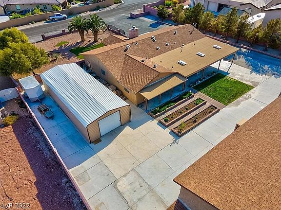Top view of house with backyard. Grass is real. Garden is ready and thriving.