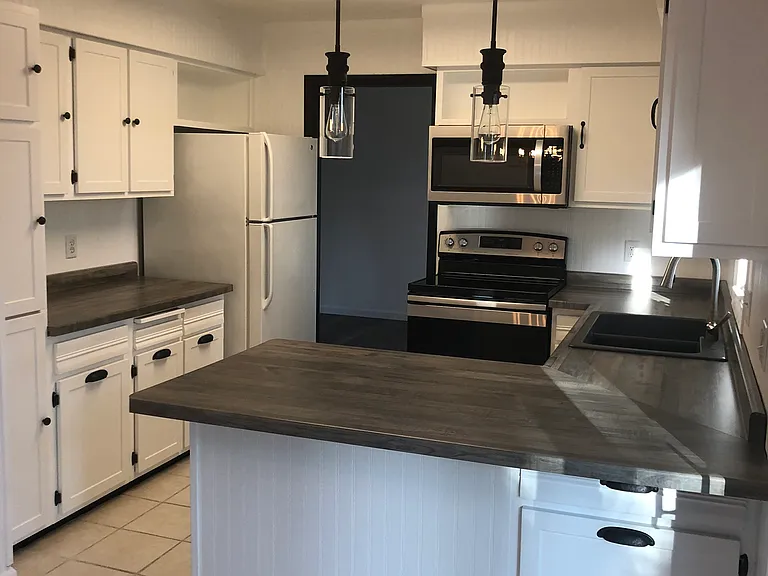 Kitchen with stove, microwave, refrigerator, dishwasher.