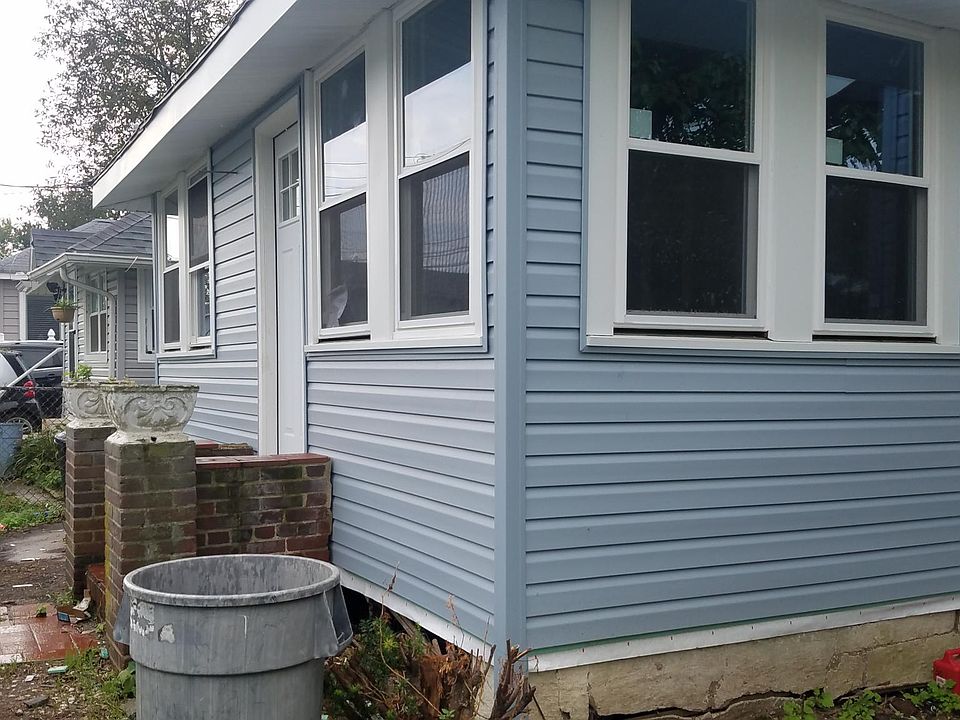 Pic from driveway front of house new siding windows and front and rear door's.