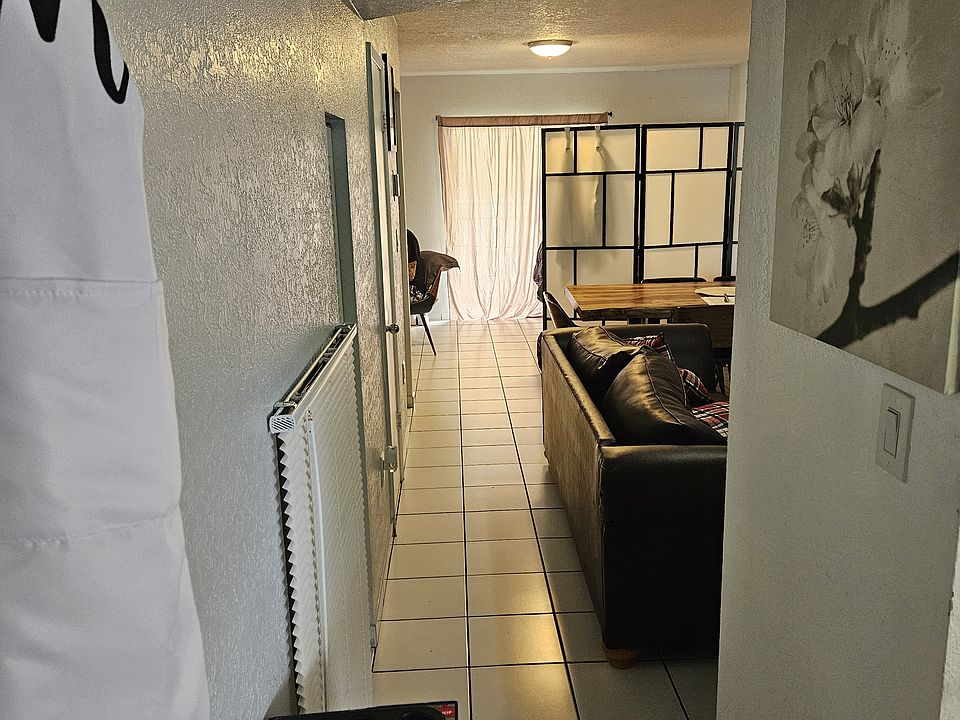 Main Entrance View, Tile Floors, living and Dining Rooms, Balcony at end