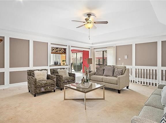 Spacious great room with custom molding & gas fireplace.