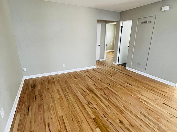 Living room from front door looking into hallway and bedrooms. Kitchen is to the right of this photo.