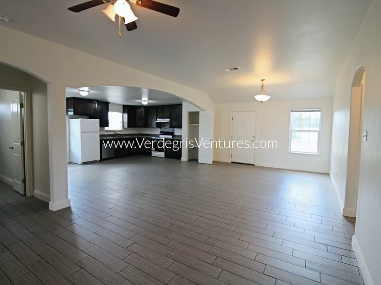 A spacious, open_concept layout connecting the kitchen, living, and dining areas.