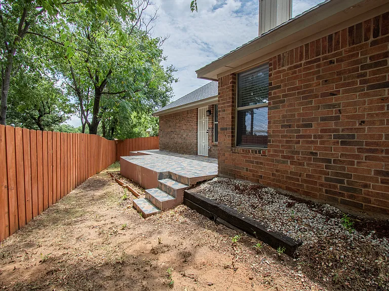 Standing at the corner of the house looking back at the back porch