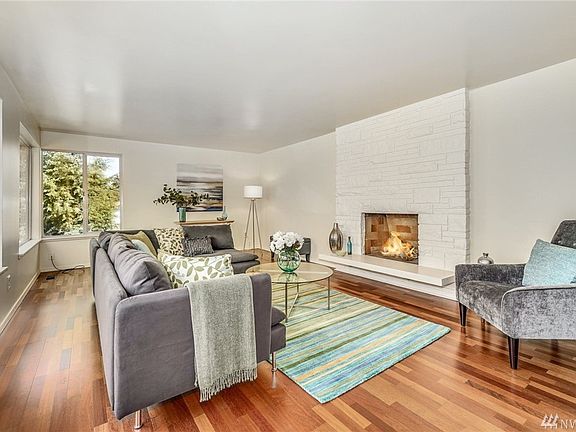 Gorgeous floor to ceiling brick wood burning fireplace with contemporary slab hearth.