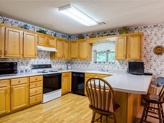 Well maintained cabinets, a great bar with seating for 4.