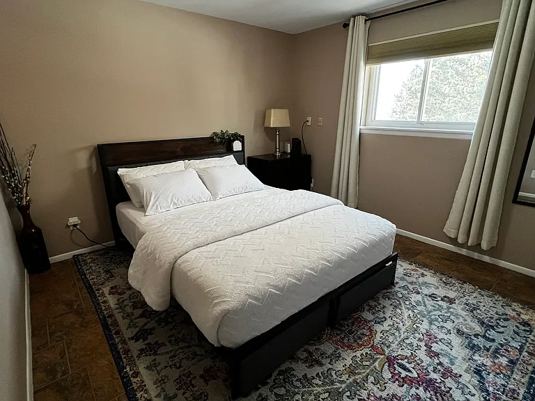 Garden-level bedroom with attached 3/4 bathroom for added privacy and convenience.