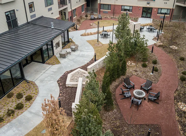 A fire pit and cozy seating areas create an inviting outdoor space perfect for gathering and unwinding.