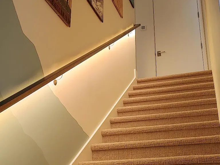 Stairwell with under stair rail recessed LED lighting