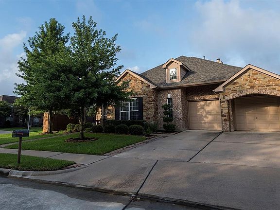 The brick and stone home sits on a premium corner lot in a cul-de-sac. The stone elevation and mature landscaping adds to the lovely curb appeal.