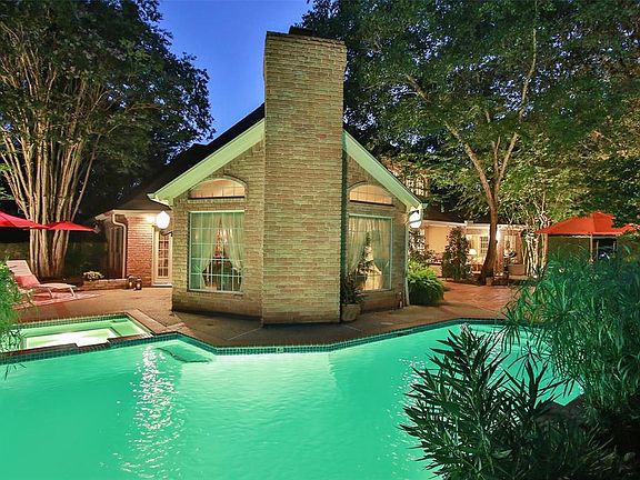 JUST OVER 15,000 SQUARE FEET OF PROPERTY. This private and expansive back yard is stunning and perfect for entertaining. Notice the multiple areas to place your outdoor furniture. This breathtaking photo is looking back at the house from the rock wat