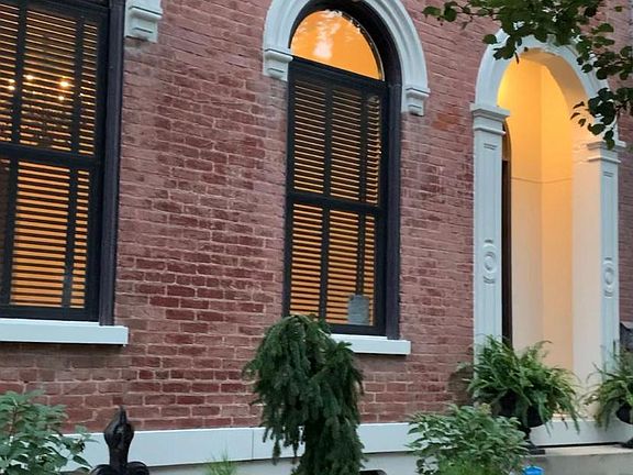 Lovely entry with new heirloom roses getting ready to climb the original iron fence