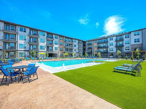 view of swimming pool featuring a lawn and pool water feature