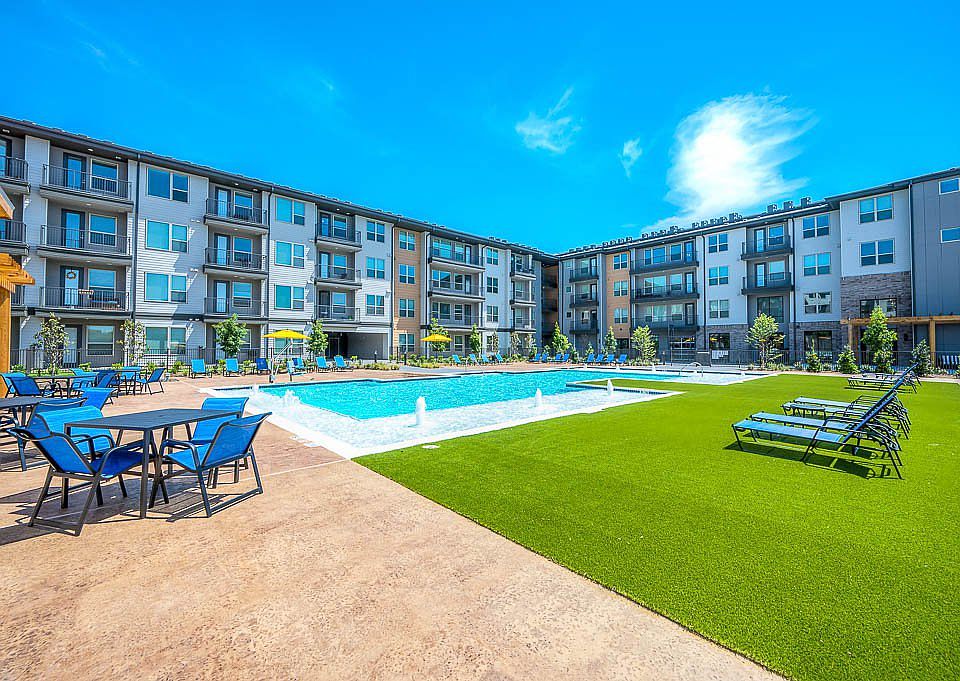 view of swimming pool featuring a lawn and pool water feature