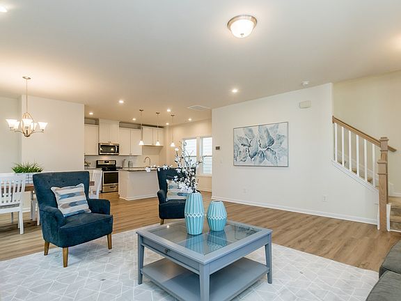 The open-concept floorplan connects the kitchen to the living and dining areas.