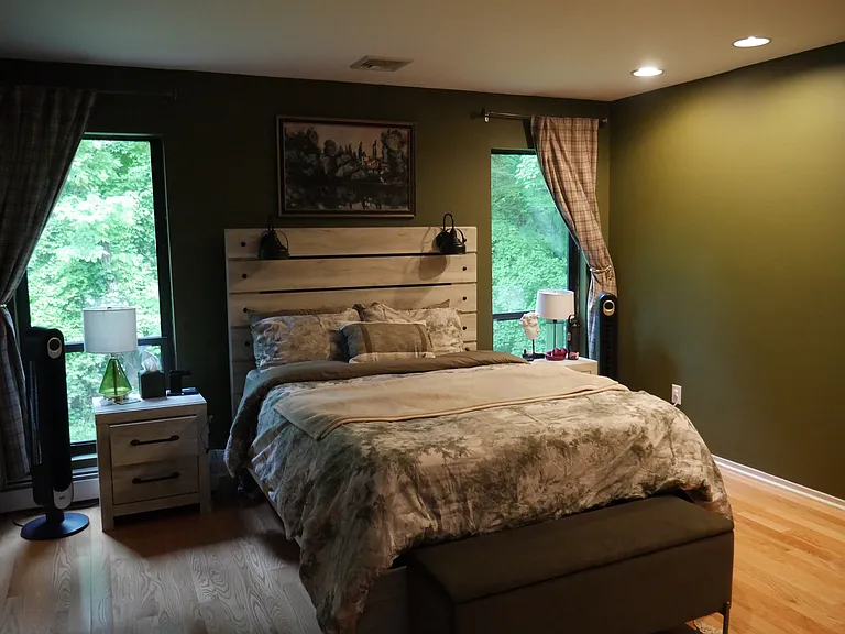 Gorgeous bedroom view overlooking a creek and woods