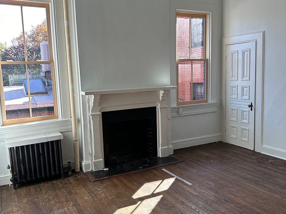 Living room area with decorative fireplace.