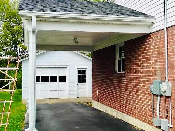Home has a detached garage, carport, and paved additional front parking.