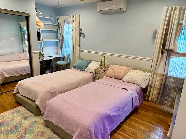 Master bedroom set up with two twins but can be a king, with a desk