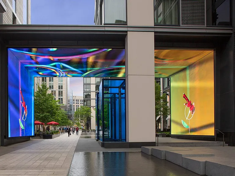 A vibrant digital art installation lights up this pedestrian passageway at CityCenterDC, where modern architecture meets immersive visual experiences in a dynamic urban space.