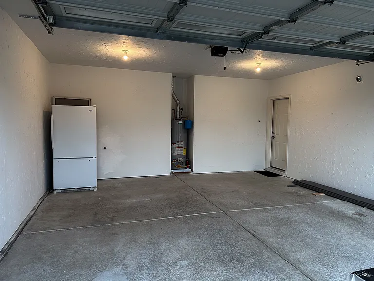 Additonal full size refrigerator with freezer in garage.