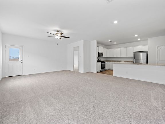 Spacious living room that connects to the kitchen and dining area.