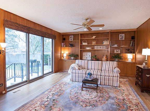 Beautiful pecan panelling and hardwood floors.  Large slider leads to brick paver patio.