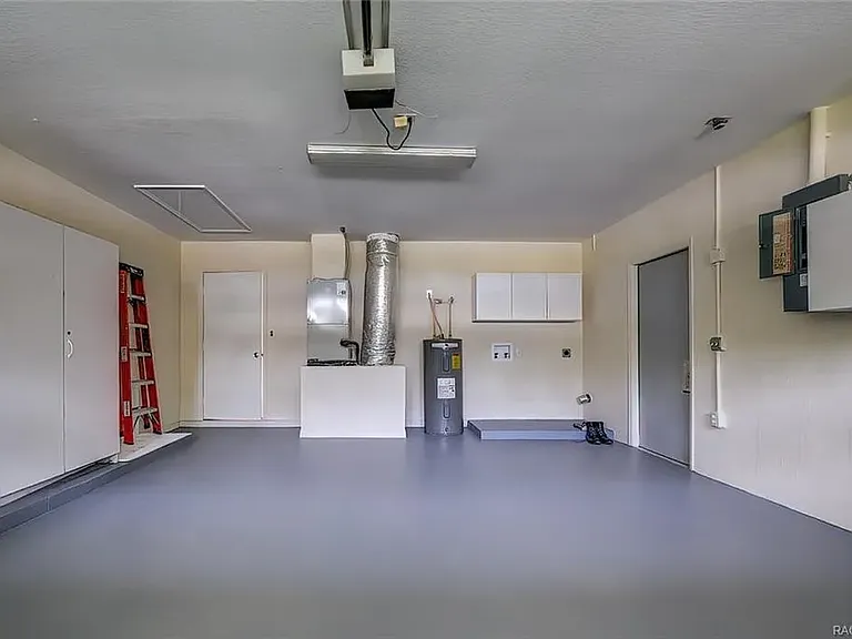 Garage walls are now painted black with black washer and dryer. Cabinets are still white.