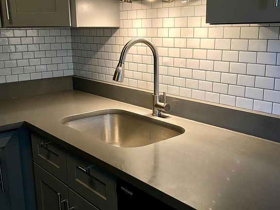 New quartz countertops and sink with sprayer hose and food disposal. Over sink LED lighting on dimmer switch for softer ambiance