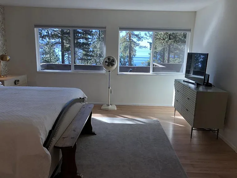 Large windows give lots of natural light to master bedroom. Lake views!