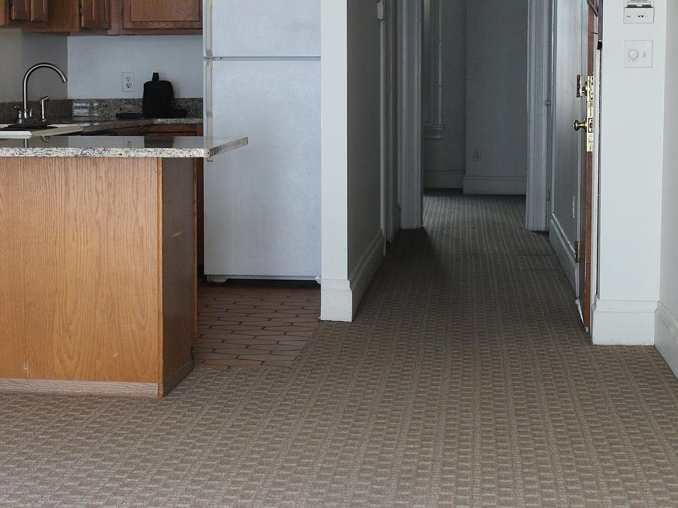View from living room to bedroom at end of hallway.