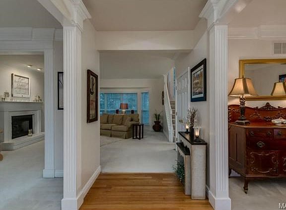 Wood floor in foyer and notice all the wood trim!