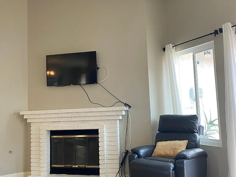 Living room with fireplace, ceiling fan