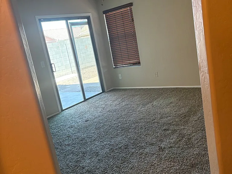 Master bedroom with a sliding door leading to the backyard.