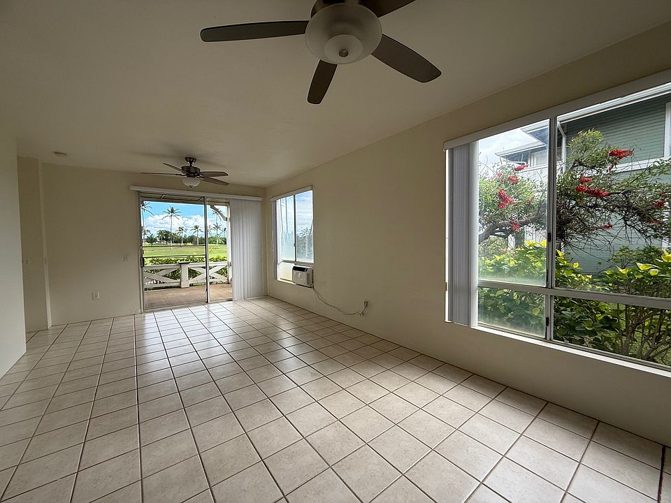 The living room have large doors that lead to a private lanai