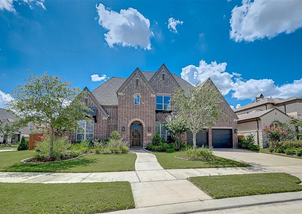 Beautiful Highland home situated on an over-sized lot with dramatic gabled roofing and stunning red brick elevation with herringbone trim. Notice the arched covered porch leading to the regal oak front door and meticulously manicured front yard addin