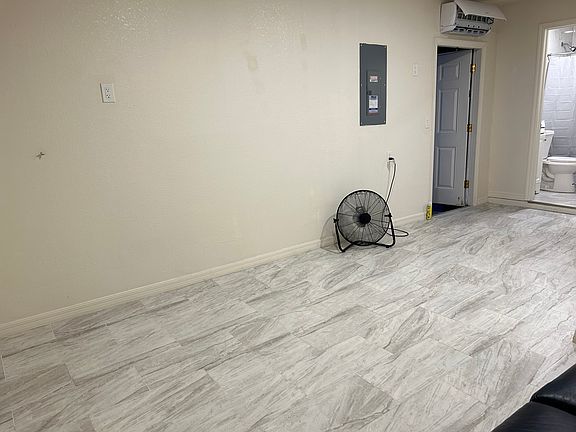Open-concept layout with modern tile flooring throughout.
