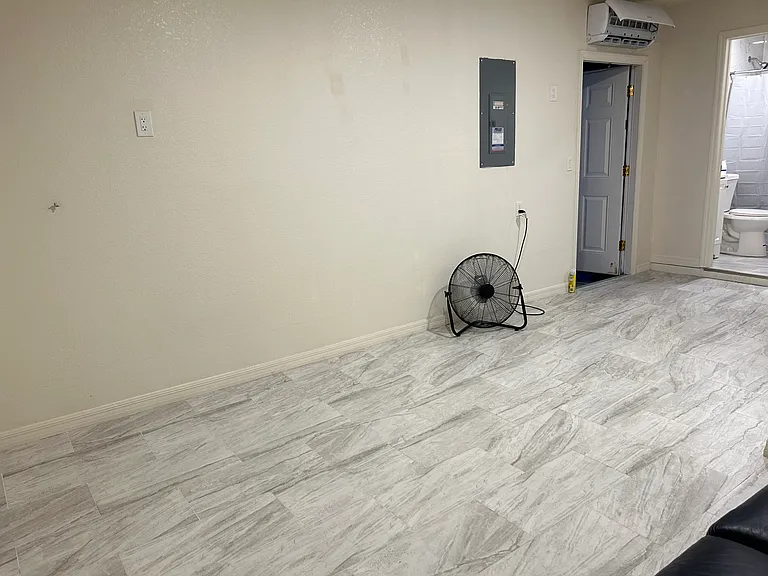 Open-concept layout with modern tile flooring throughout.