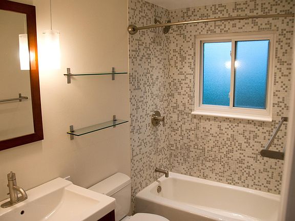 Completely remodeled bathroom with custom glass mosaic tile