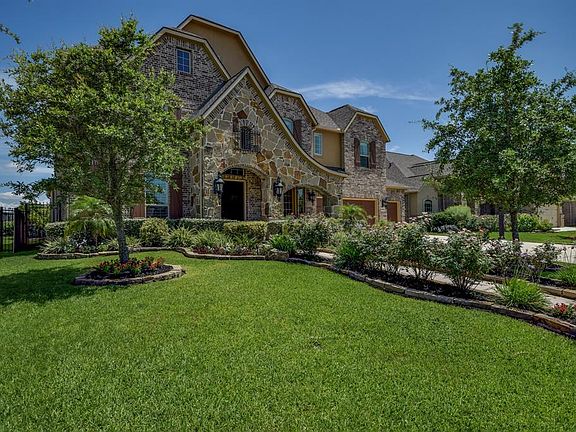 Beautiful lush landscaping and lighting lead into this stunning home with incredible finishes and peaceful surroundings.
