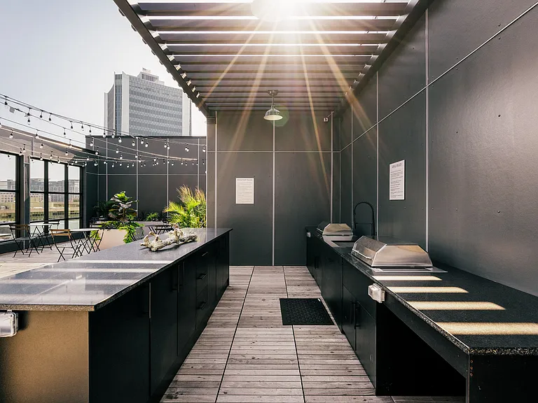 Rooftop bar area with grills and prep counters