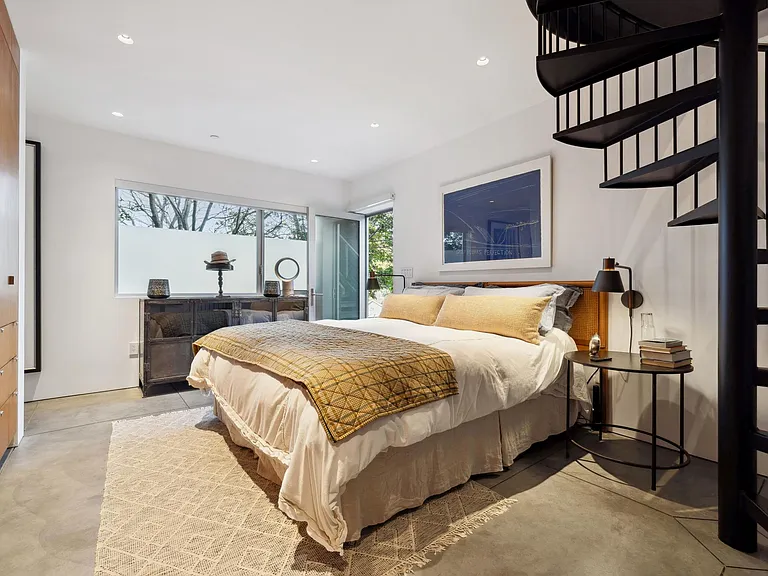 Main bedroom with kingsize bed and built in closets and dressers.