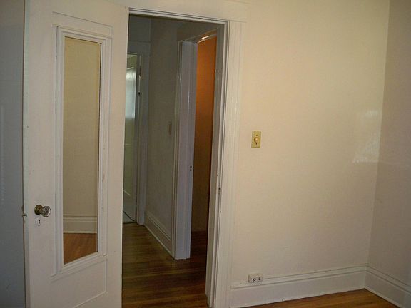view of hall way to living room and bathroom from bedroom