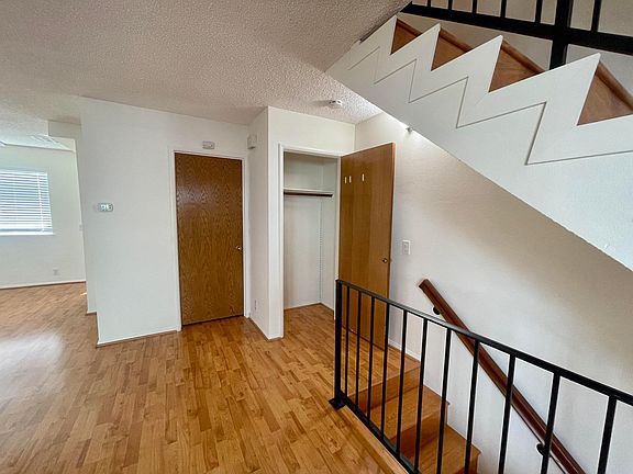 At the top of the stairs is a closet, half-bath and open living/dining room.