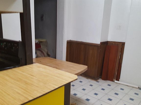 Entry way to the kitchen, bathroom areas, near exit door to the patio.