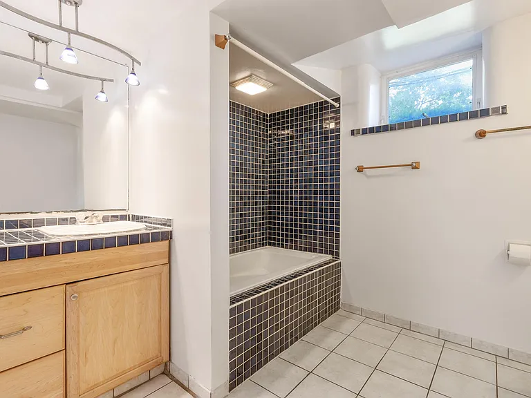 Large Custom Bath: Jacuzzi (jetted) tub/shower in Italian blue ceramic tile surround! Vanity with lots of cabinet space + linen closet for towels, sheets. Cool lighting makes for a bright light bathroom! All Kohler plumbing fixtures!